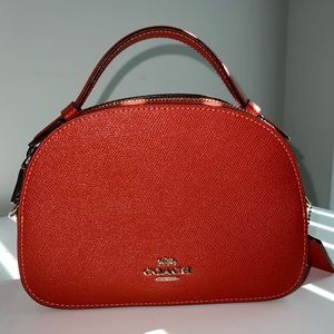 Small burnt orange leather Coach Purse with adjustable shoulder strap